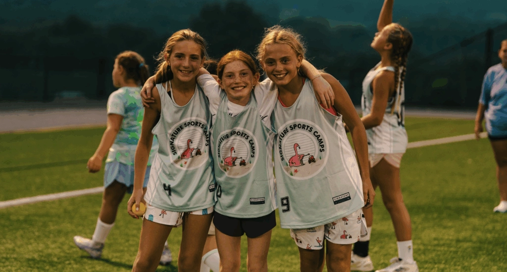 Smiling female athletes after training at Signature Sports Camps summer sports camp.