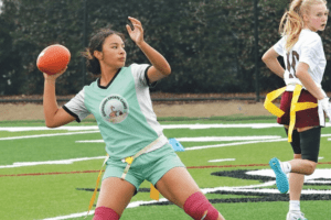 Girl playing Flag Football at camp.