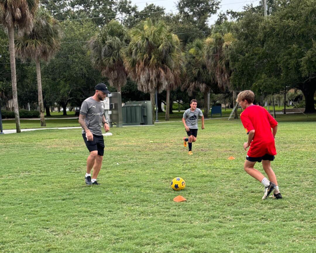 Pro soccer player Nicky Law giving instruction during soccer practice at signature sports camps