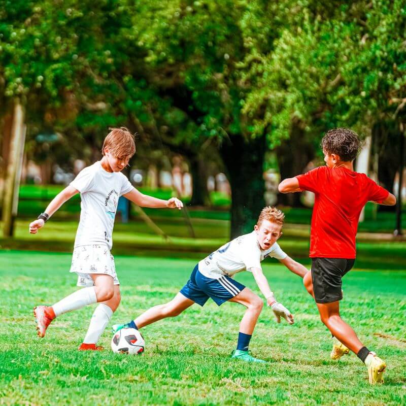 Boys playing a 3 v 3 soccer tournament at overnight soccer camp