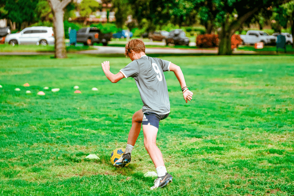 Boy at Signature Sports Camp practicing soccer drills