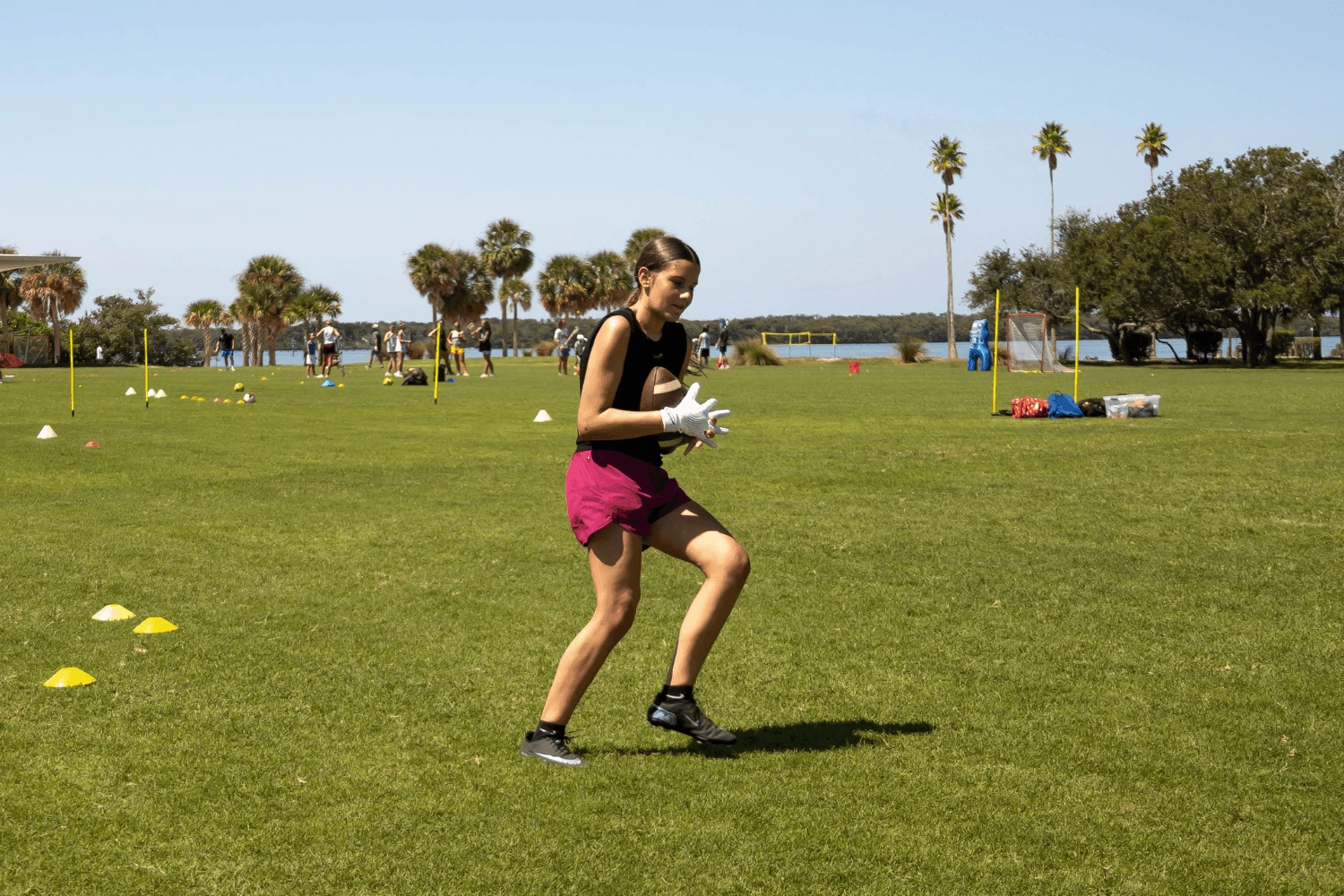 Girl at Signature Sports Camps practicing drills during flag football session