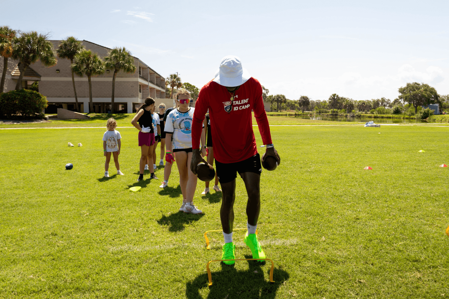 Flag football coach instructing campers during Signature Sports Camps