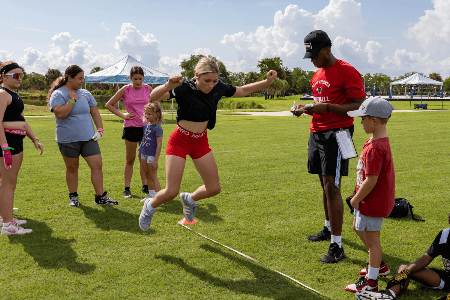 flag football slider 13.png Girl jumping during flag football practice session at Signature Sports Camps