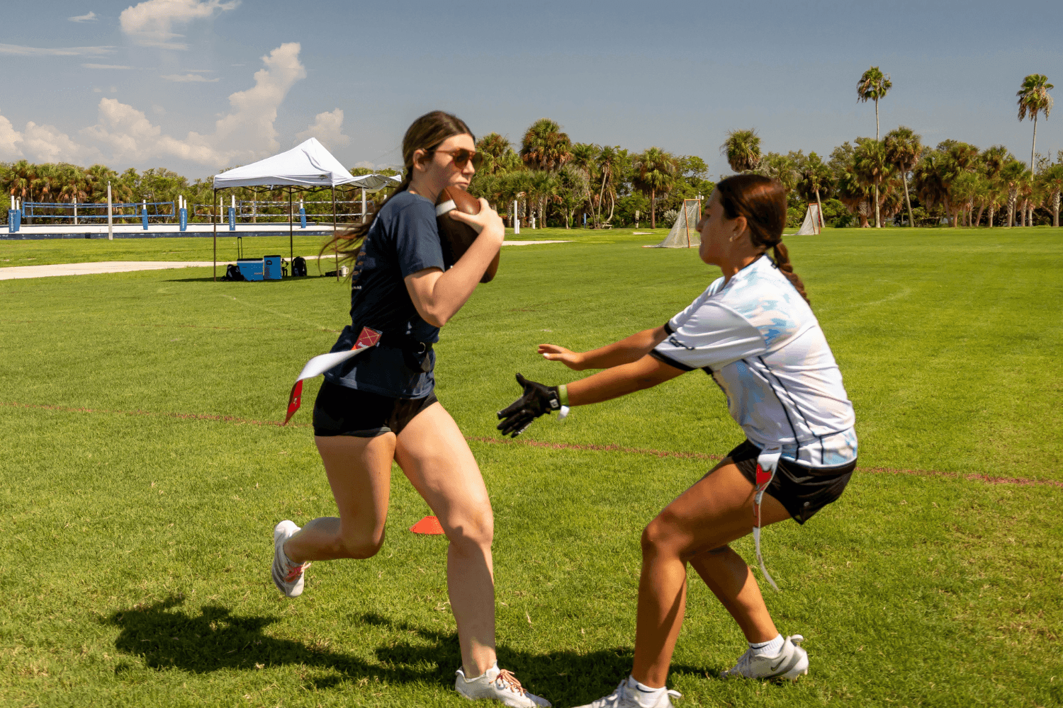 Girls at Signature Sports Camps during flag football practice outdoors