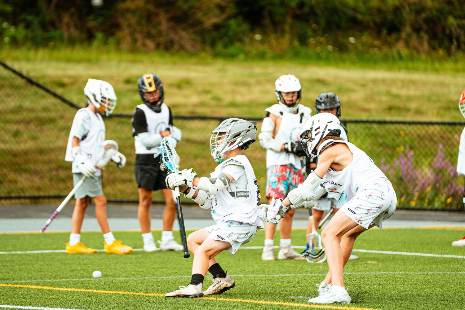 Boys action shot during a lacrosse scrimmage at sports camp