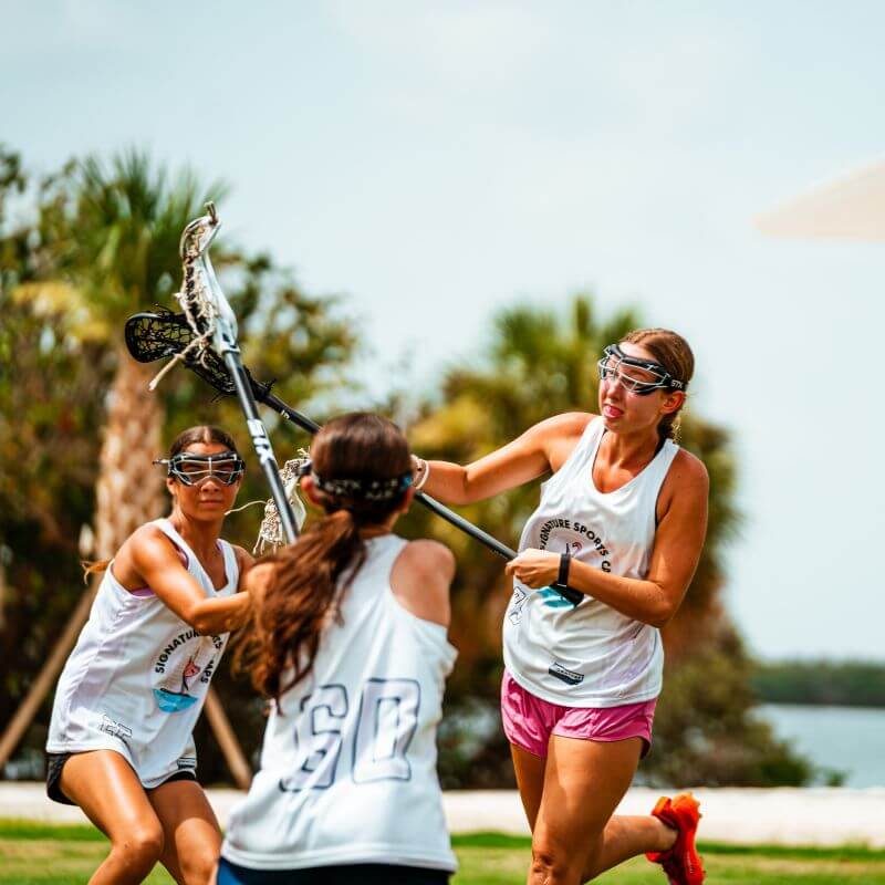 Girls playing lacrosse at signature sports camp in FL