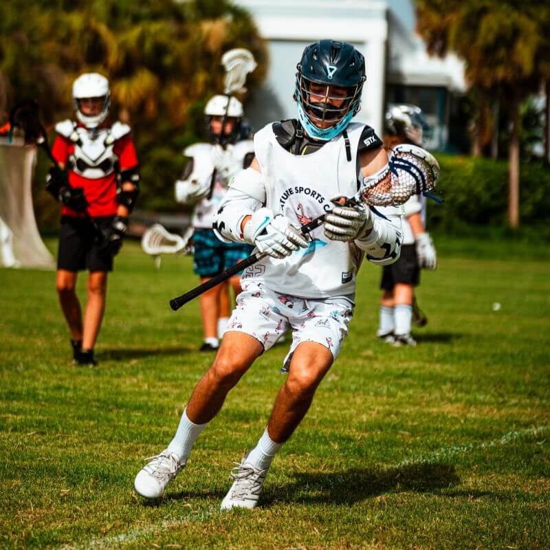 Boy practicing drills at lacrosse camp
