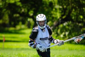 A lacrosse player practicing cradling, a lacrosse drill for beginners