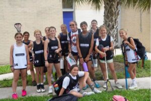 A group of lacrosse players wearing backpacks ready for overnight lacrosse camp