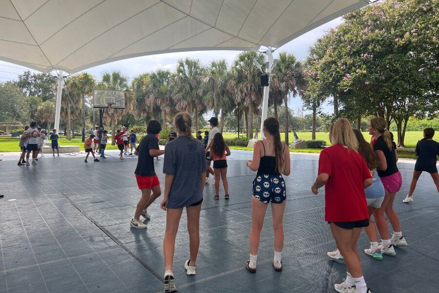 Lacrosse camp group activities under an outdoor pavilion