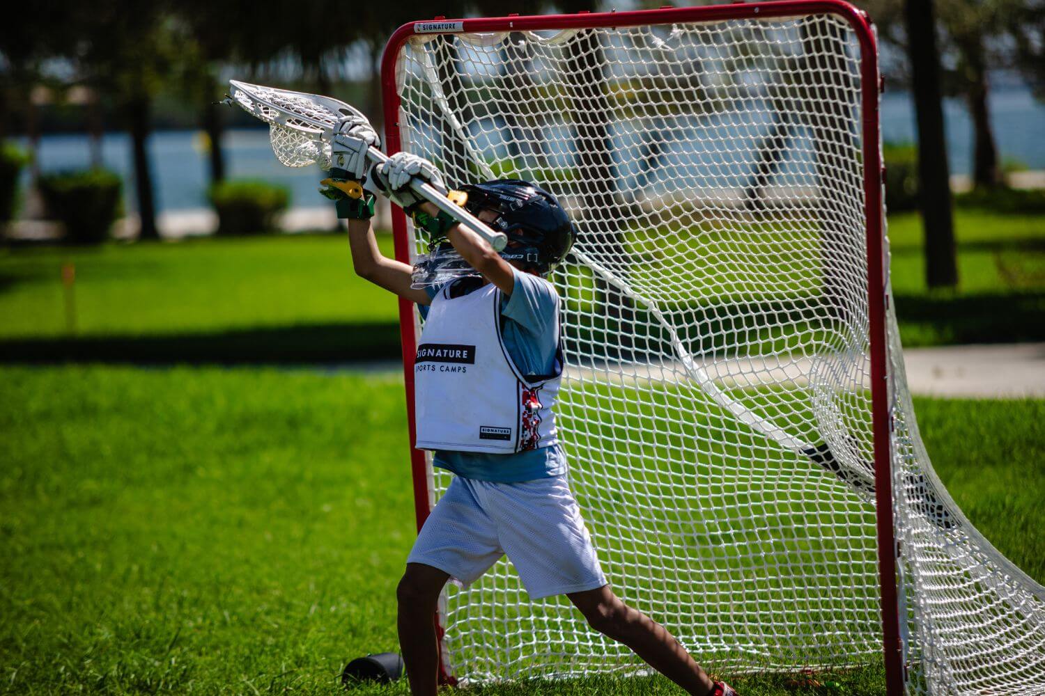 Young lacrosse player at goalie position during a summer camp scrimmage