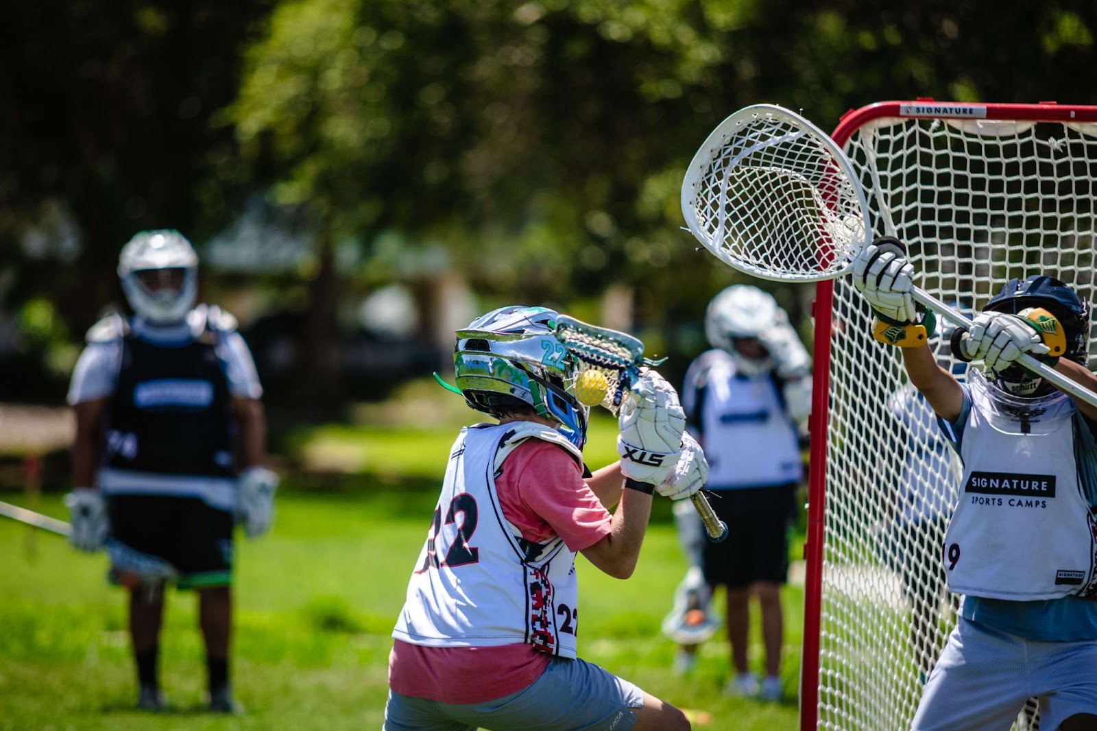 Two lacrosse players engaged in a game during summer sports camp