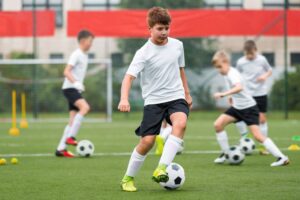 A group of youth soccer players during practice at overnight summer camp