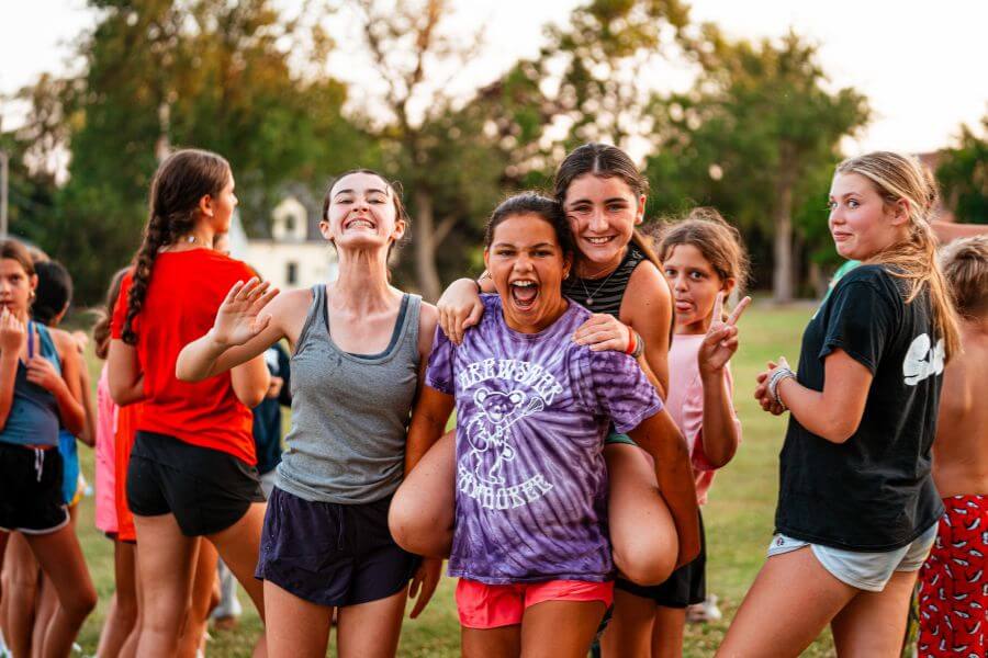 Group of girls smiling for a photo at summer camp