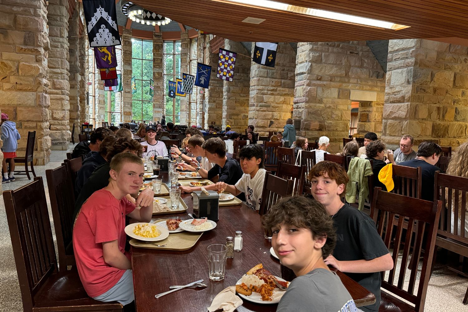 Boys sitting at a table in the dining hall at Signature Sports Camp