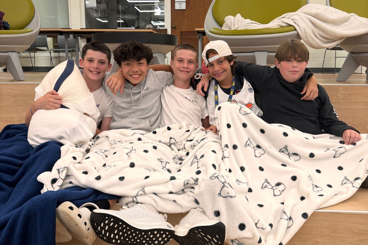 Boys pose for a photo together during movie night at overnight summer camp