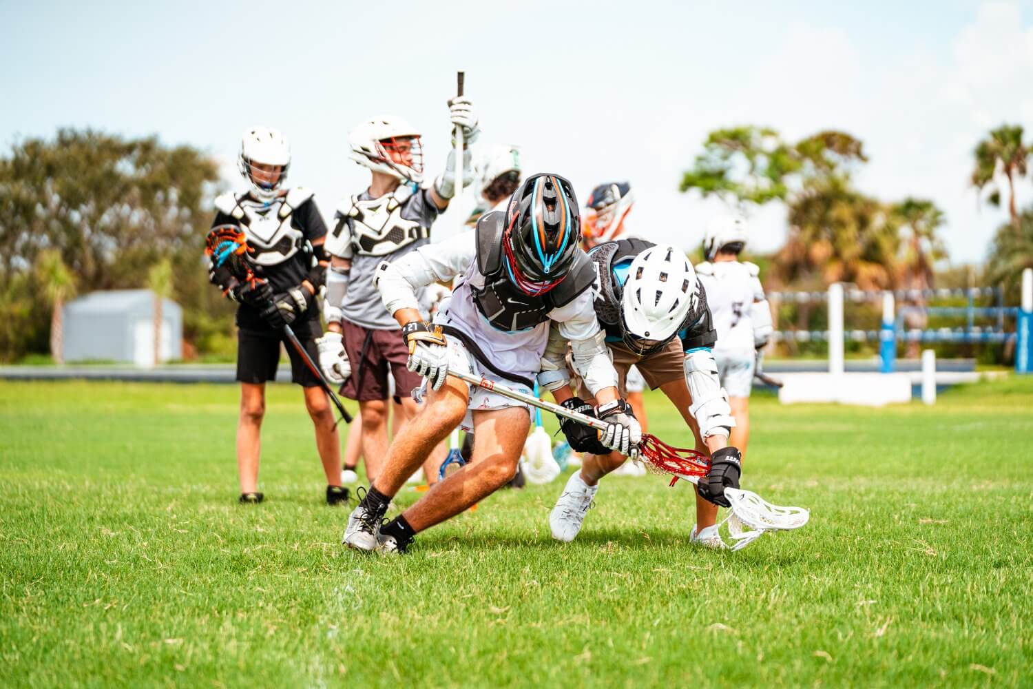 Lacrosse players going head to head during a game at Signature Sports Camp