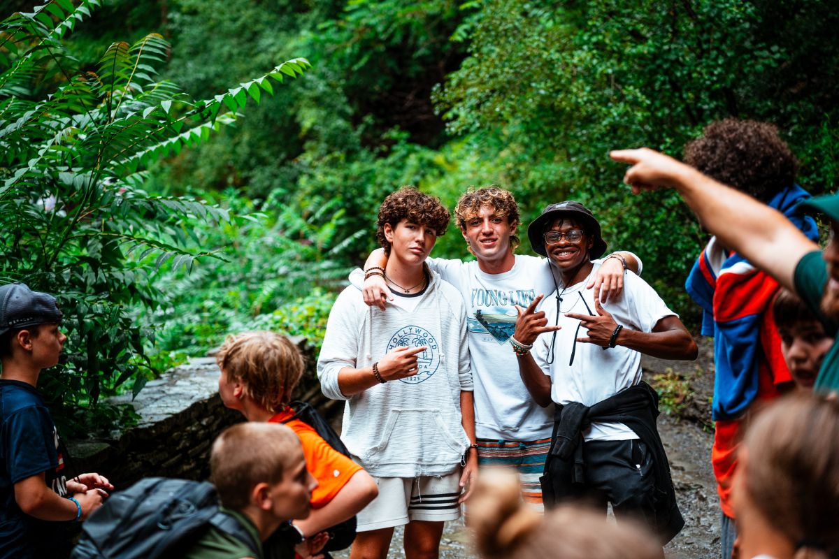 Boys pose for a photo during a hike while at overnight sports camp