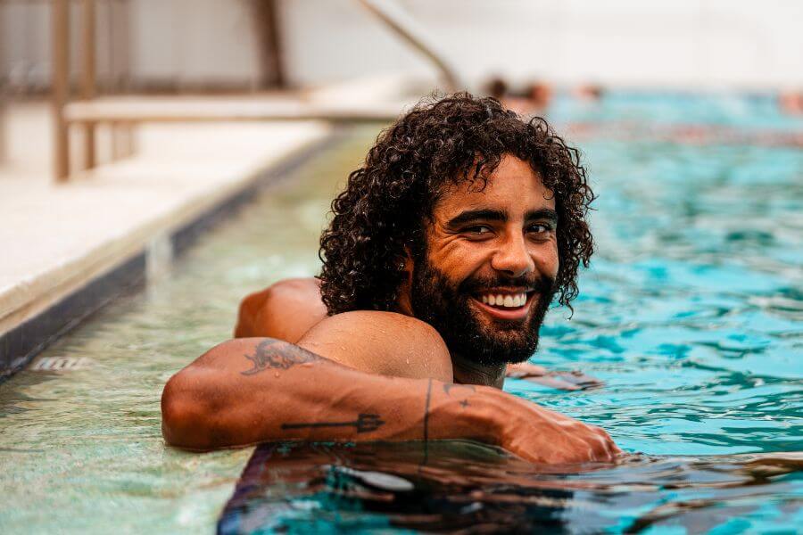 Signature Sports Camp coach relaxing in a swimming pool