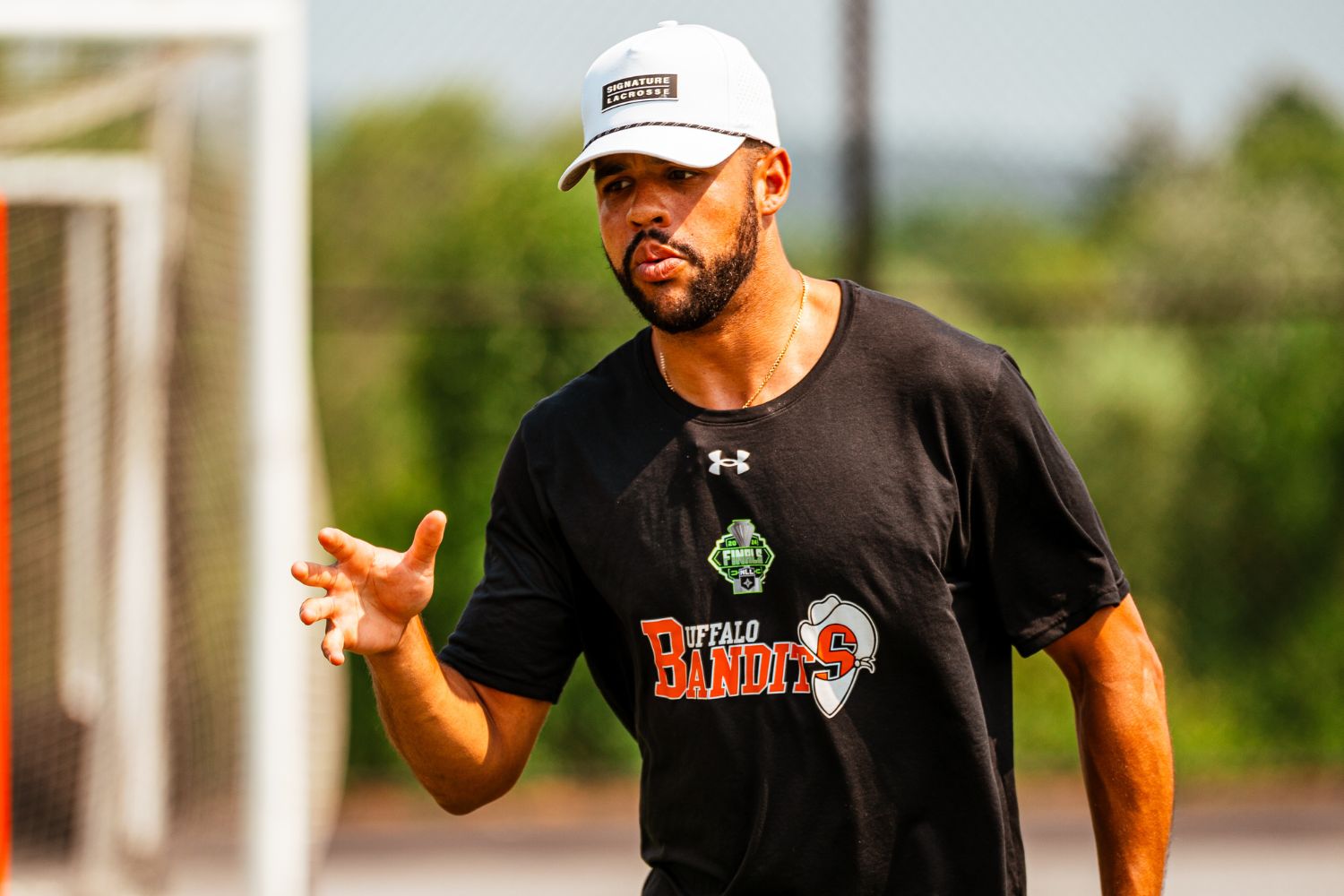 Professional lacrosse player Dhane Smith talking to campers