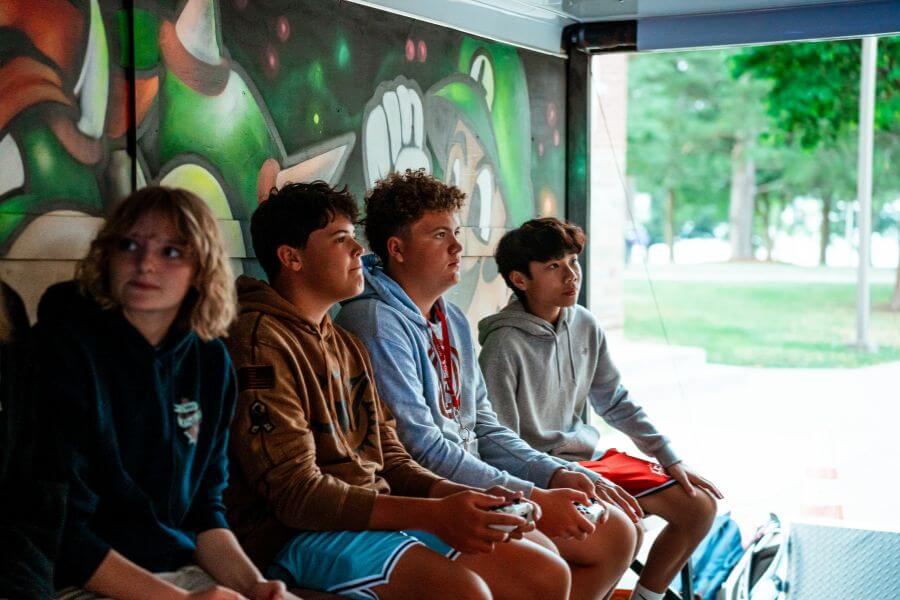 Boys at Signature Sports Camp enjoying time in the Video Game truck