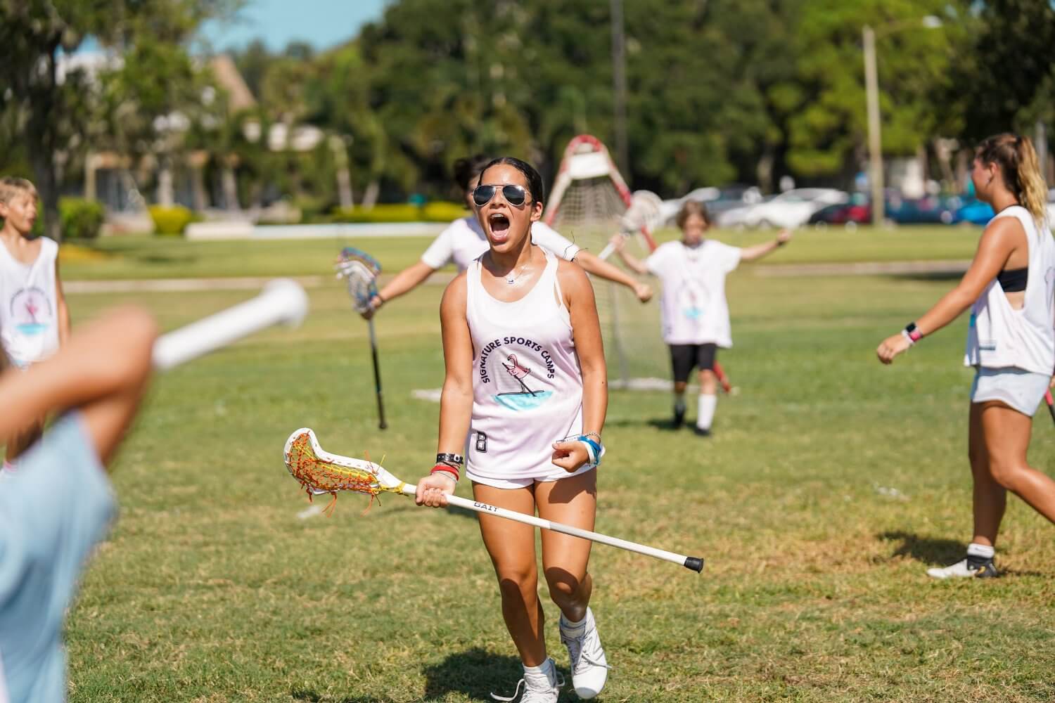 Girl celebrating a win during lacrosse scrimmage at camp