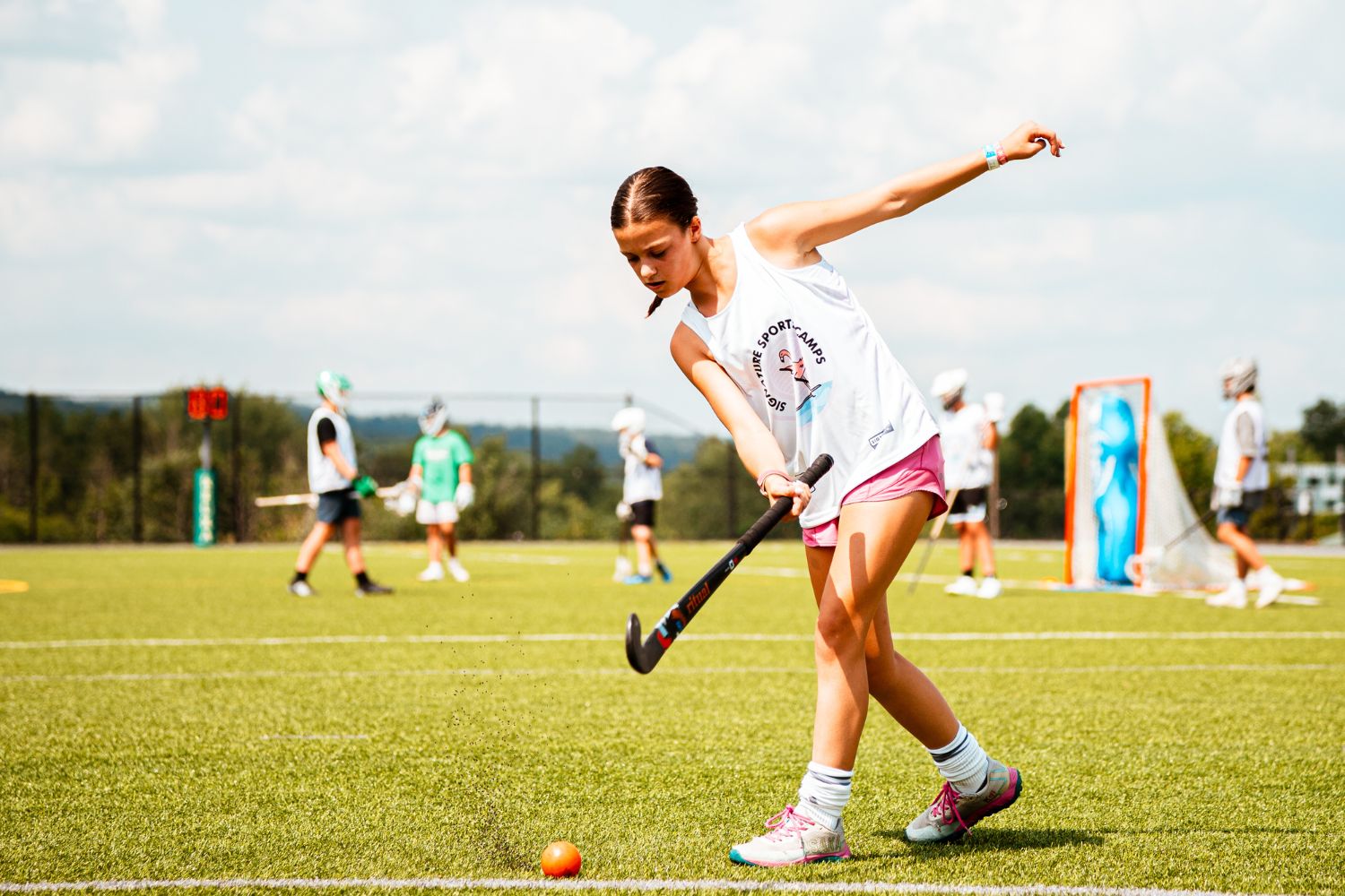 Girl wearing a Signature Sports Camp jersey during field hockey practice