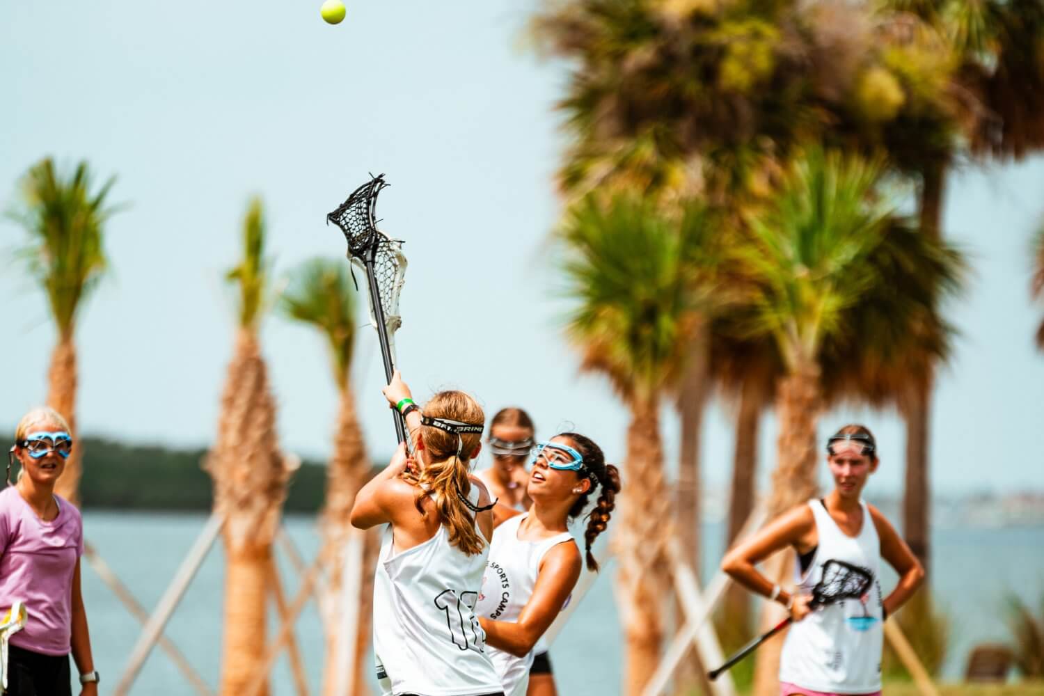 Girls going head to head during a lacrosse match