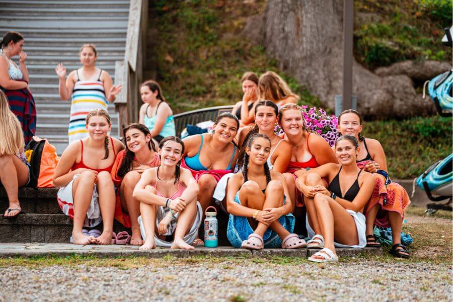 Girls at sports camp pose for a photo during lake time