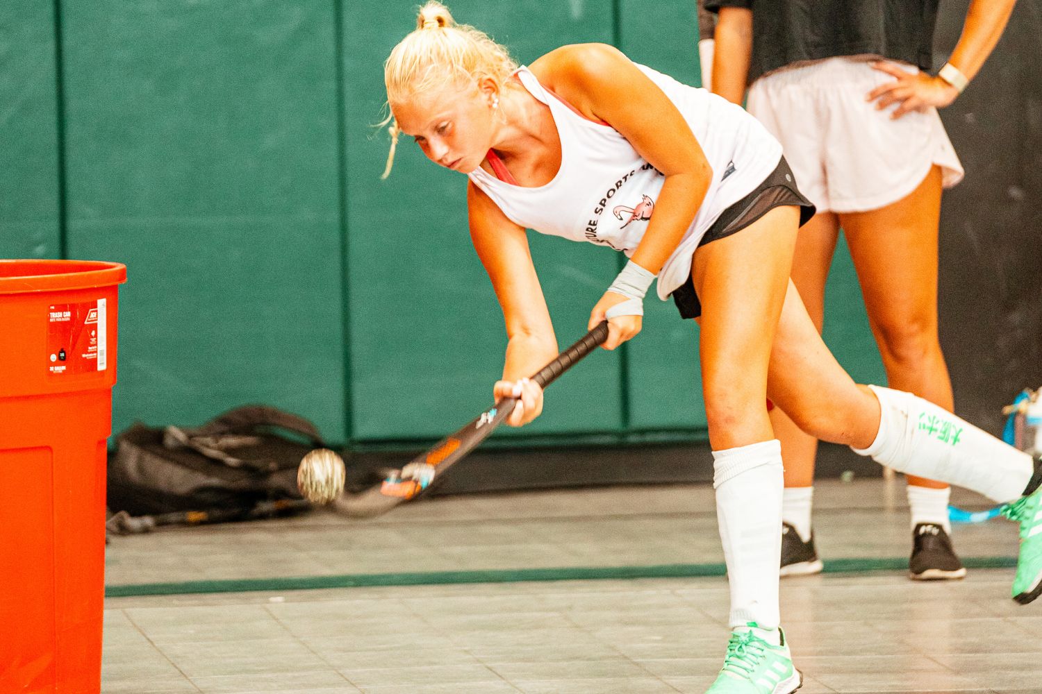 Girls action shot during indoor field hockey practice