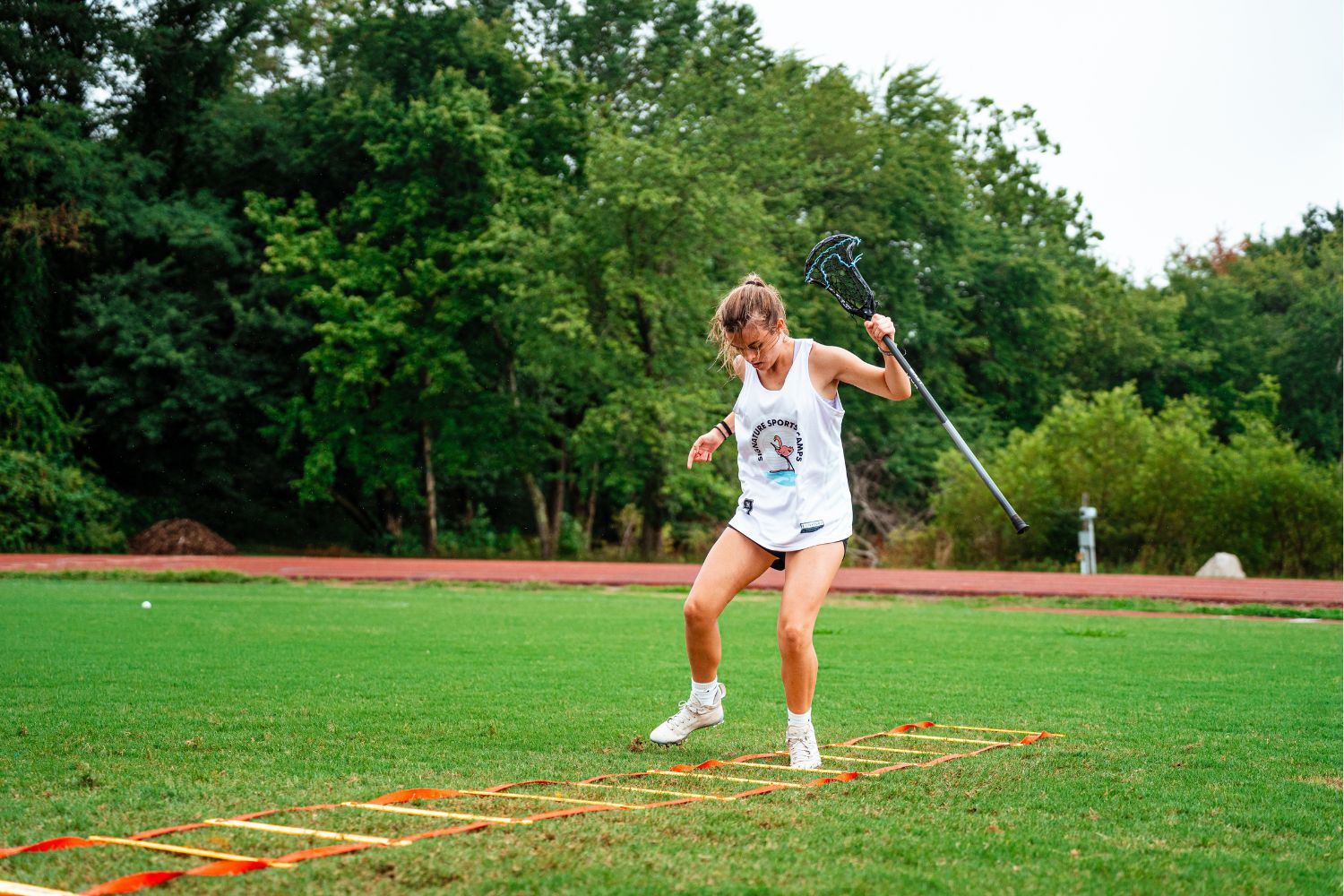 Girl at lacrosse practice doing speed drills