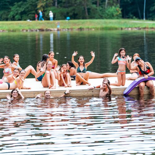 Kids attending Signature Sports Camp enjoying a swimming break in the lake