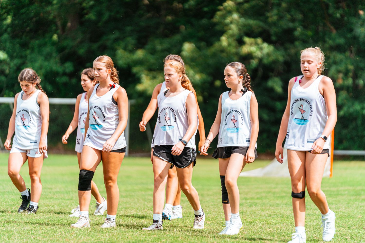 Girls walking on to lacrosse field at Signature Sports Camp