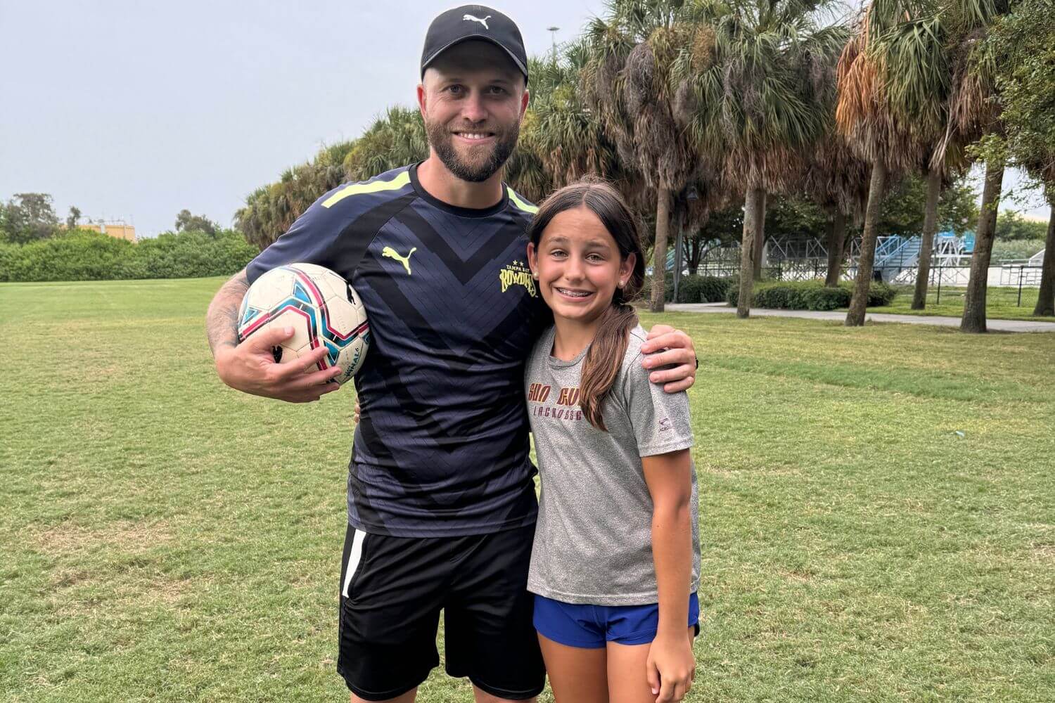 Pro soccer player Nicky Law with a camper at Signature Sports Camp