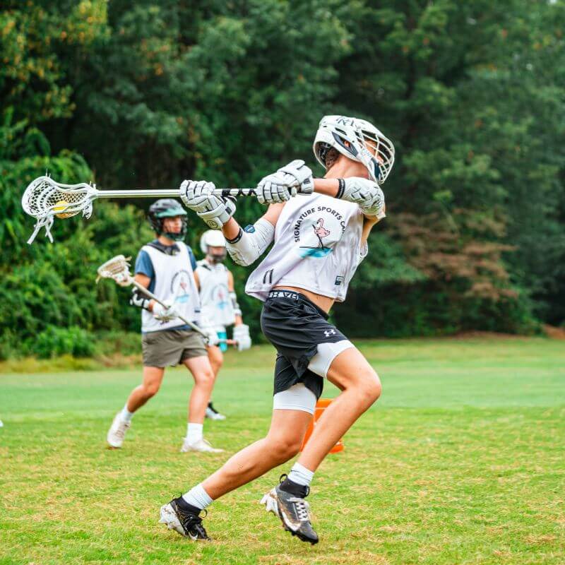 Action shot of a lacrosse player at Signature Sports Camp