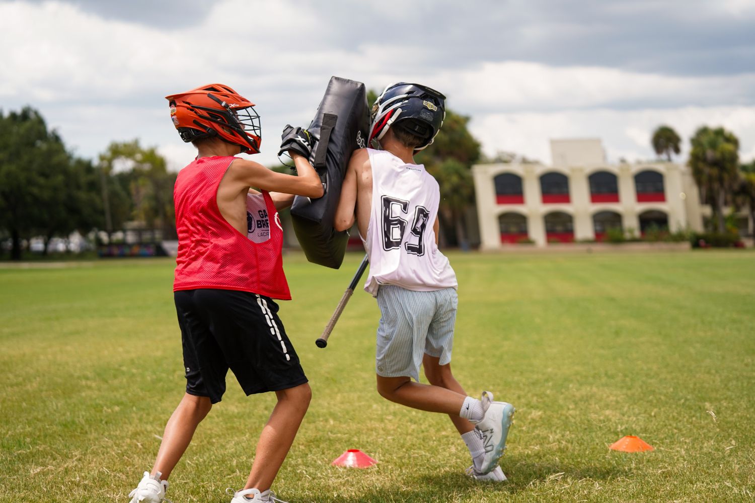 Boys practicing defensive drills during lacrosse practice at overnight sports camp