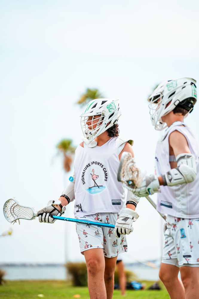 Two lacrosse players in action during practice at overnight sports camp