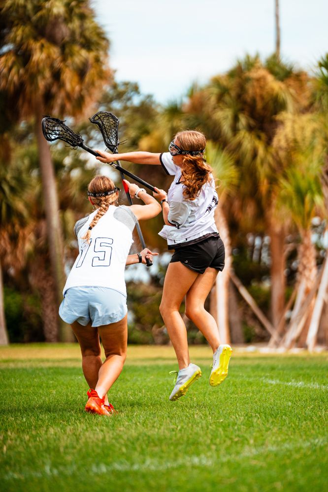 Girls lacrosse players in action during practice at overnight sports camp