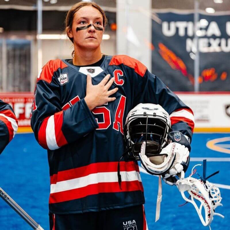 Team USA lacrosse captain Emily Hawryshuck holding her hand to her chest during National Anthem