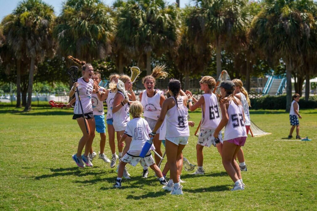 A group of lacrosse players at sports camp celebrating together after a tournament win