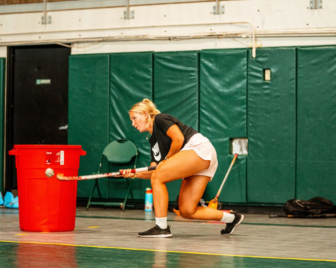 Professional field hockey player providing demonstration during field hockey practice at Signature Sports Camps