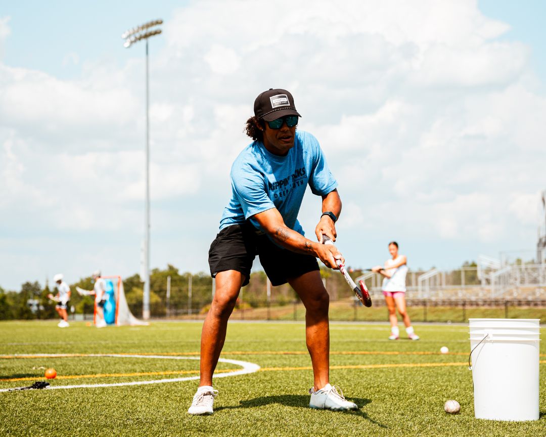 Field hockey coach providing demonstration at signature sports camp