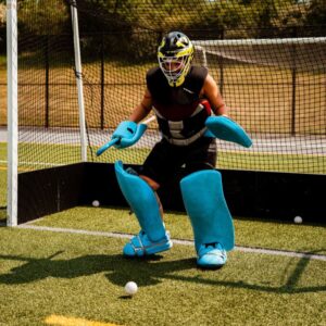 Field hockey goalie doing position drills at overnight field hockey camp