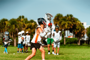 Young lacrosse players on the field practicing at Signature Sports Camp in Florida