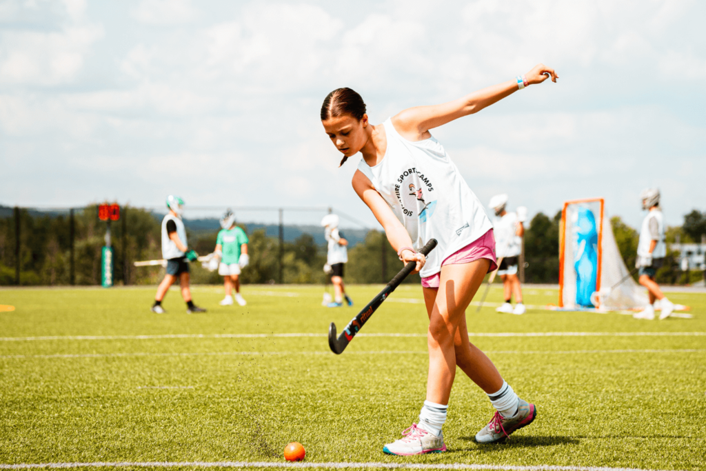 Girl at Signature Sports Camp in NY practicing field hockey