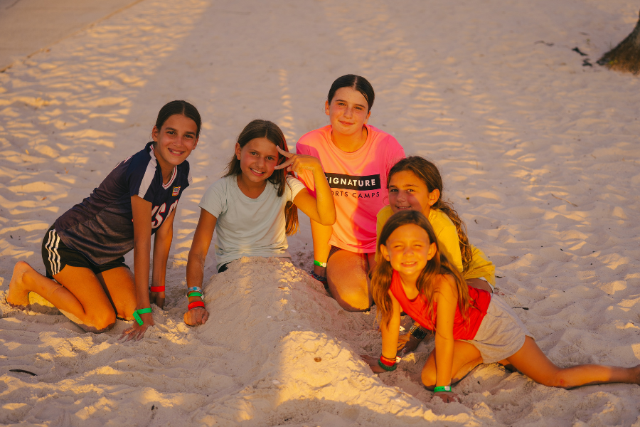 girls playing in the sand during an evening at overnight sports camp in florida