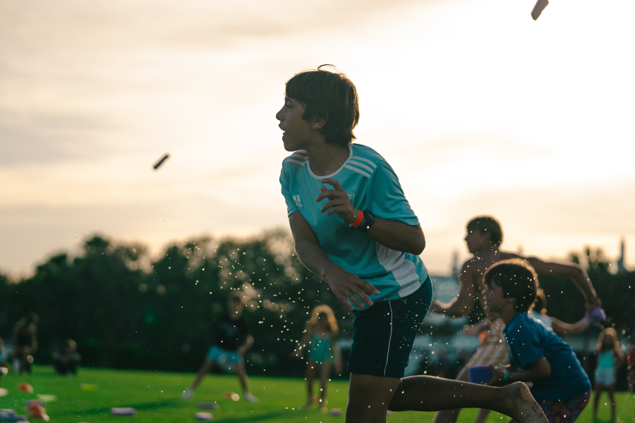 boy playing medicine man at overnight sports camp