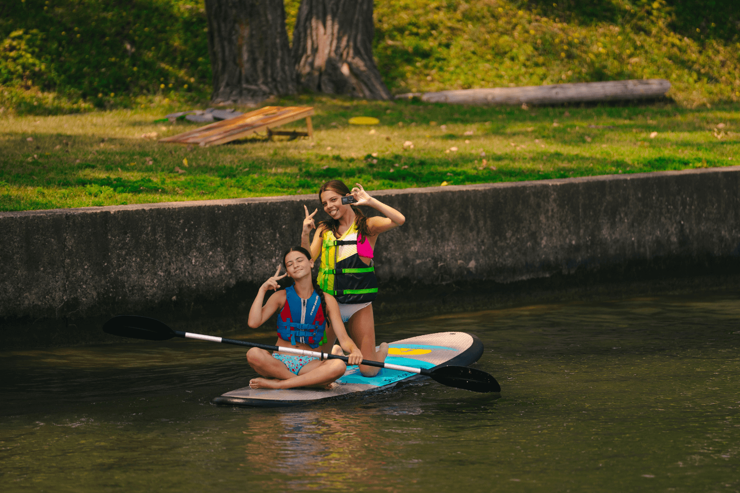girls at overnight sports camp enjoy an afternoon paddleboarding