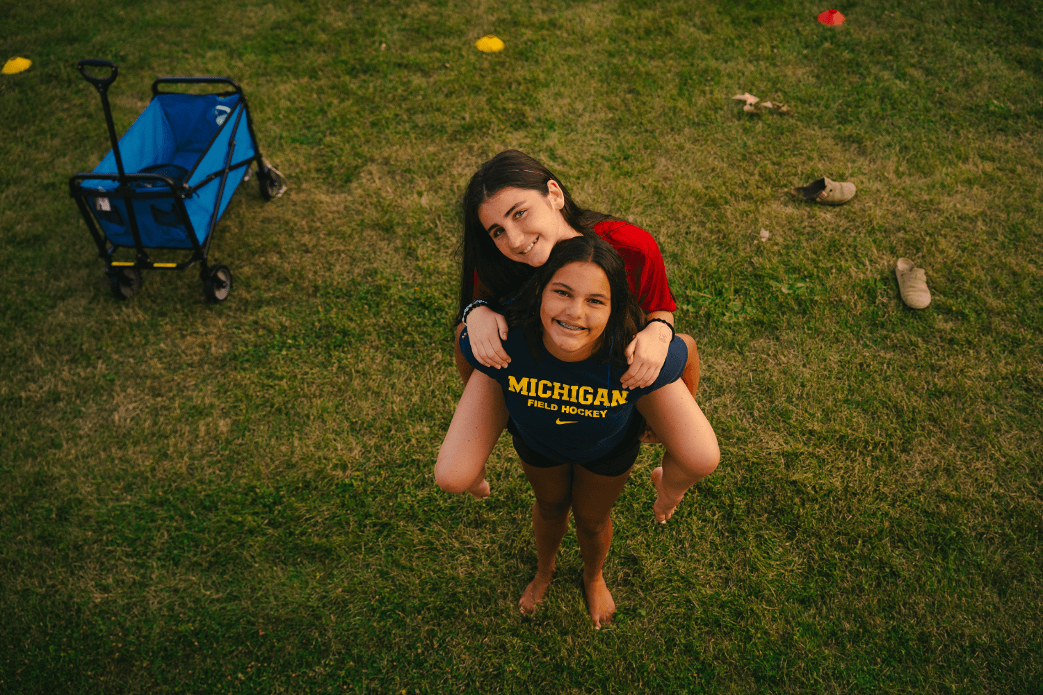 girls smile for a photo at overnight sports camp in new york